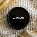 An arial view of an open container of Dixie Belle Paint Company's Anchor Silk All-In-One Mineral Paint is shown with white text reading Anchor