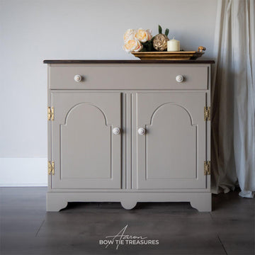 A small buffet table refurbished by Aaron Bow Tie Treasures features Dixie Belle's Badlands Silk All-In-One Mineral Paint.