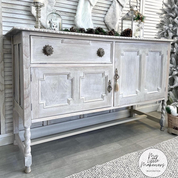 A vintage console table with storage refurbished by My Little Makeovers Restoration features Dixie Belle's Baja Gray Silk All-In-One Mineral Paint used as a white wash.