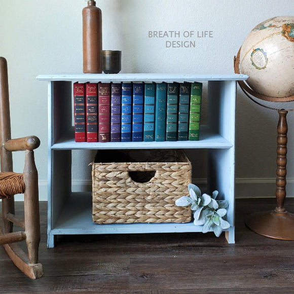 A nightstand with 2 open shelves refurbished by Breath of Life Design features Dixie Belle's Bay Breeze Silk All-In-One Mineral Paint.