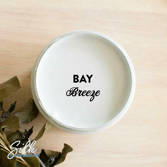 An arial view of an open container of Dixie Belle Paint Company's Bay Breeze Silk All-In-One Mineral Paint is shown with black text reading Bay Breeze.