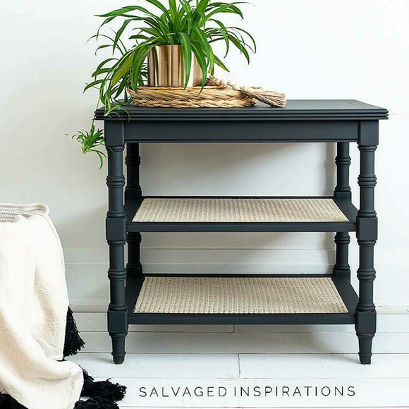 A vintage side table with 2 shelves refurbished by Salvaged Inspirations features Dixie Belle's Black Sands Silk All-In-One Mineral Paint.