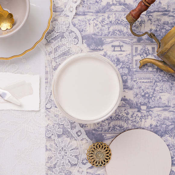 white paint on a blue patterned table.