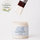 Silk All-in-One Mineral Paint container with a brush applying paint, featuring the 'Countryside Collection' logo.