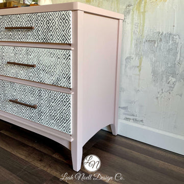 An angled side view of a large dresser refurbished by Leah Noell Design Company features Dixie Belle's Conch Silk All-In-One Mineral Paint.