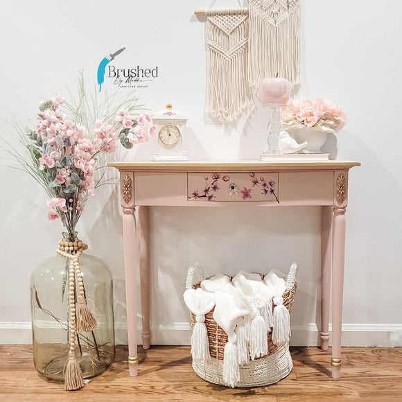 A vintage entry table refurbished by Brushed by Maddie features Dixie Belle's Conch Silk All-In-One Mineral Paint.