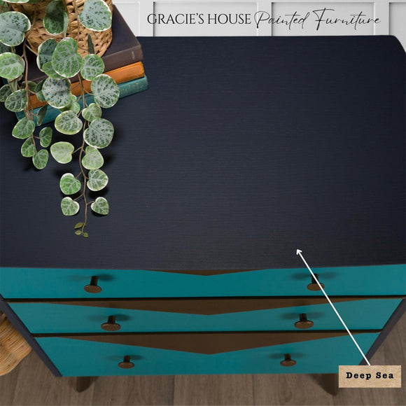 A top view of a 3-drawer dresser refurbished by Gracie's House Painted Furniture features Dixie Belle's Deep Sea Silk All-In-One Mineral Paint.