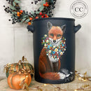 A metal can style planter refurbished by Low Flying Angels features Dixie Belle's Deep Sea Silk All-In-One Mineral Paint and a painting of a red fox with a floral wreath.