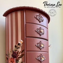 A tall vintage jewelry box refurbished by Theresa Lee NTS Design Company features Dixie Belle's Desert Rose Silk All-In-One Mineral Paint.