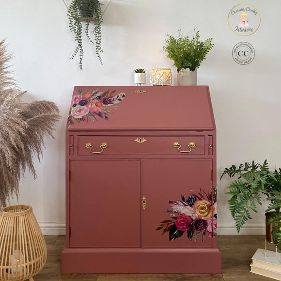 A vintage secretary's desk refurbished by Cherubs Chalks Interiors features Dixie Belle's Desert Rose Silk All-In-One Mineral Paint and floral rub-on transfers.