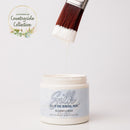 Jar of Silk all-in-one mineral paint with a brush dripping paint onto the lid, on a white background.