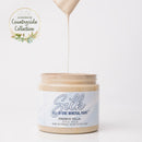 Jar of Silk All-in-One Mineral Paint with a droplet of paint on a white background