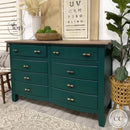 A large 8-drawer dresser refurbished by Why Not ReDesign features Dixie Belle's Midnight Green Silk All-In-One Mineral Paint with a natural wood top.