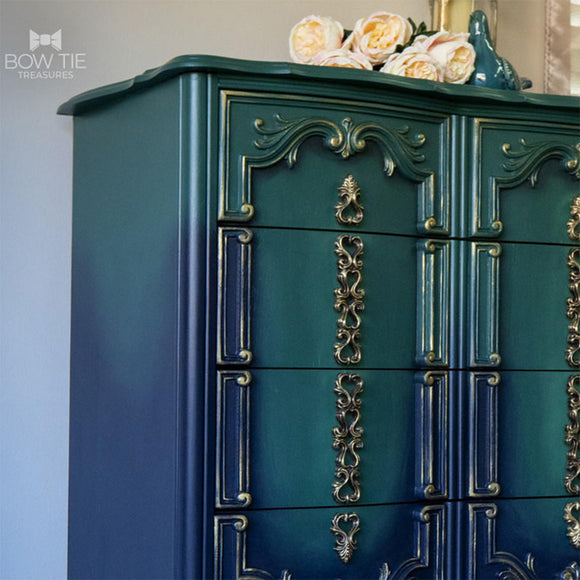 A close-up of a vintage chest dresser refurbished by Bow Tie Treasures features Dixie Belle's Midnight Green Silk All-In-One Mineral Paint.