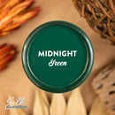 An arial view of an open container of Dixie Belle Paint Company's Midnight Green Silk All-In-One Mineral Paint is shown with white text reading Midnight Green.