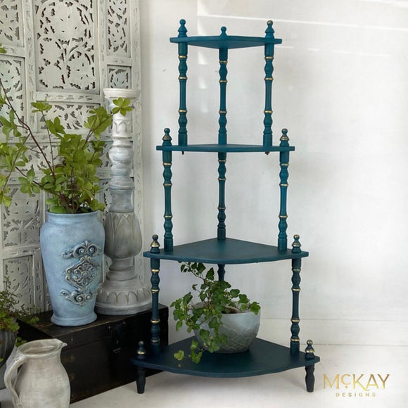 A vintage 4-tier standing shelf unit refurbished by McKay Designs features Dixie Belle's Mirage Silk All-In-One Mineral Paint with gold accents.