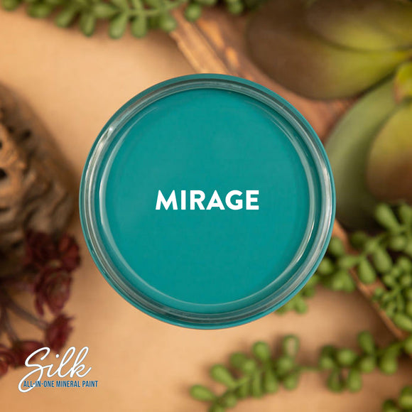 An arial view of an open container of Dixie Belle Paint Company's Mirage Silk All-In-One Mineral Paint is shown with white text reading Mirage.