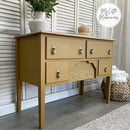 A vintage console table with 4 drawers refurbished by My Little Makeovers features Dixie Belle's Mojave Silk All-In-One Mineral Paint.