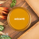 An arial view of an open container of Dixie Belle Paint Company's Mojave Silk All-In-One Mineral Paint is shown with white text reading Mojave.