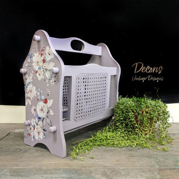 A vintage wood magazine rack refurbished by Doris Vintage Designs features Dixie Belle's Morning Sunrise Silk All-In-One Mineral Paint with floral transfers.