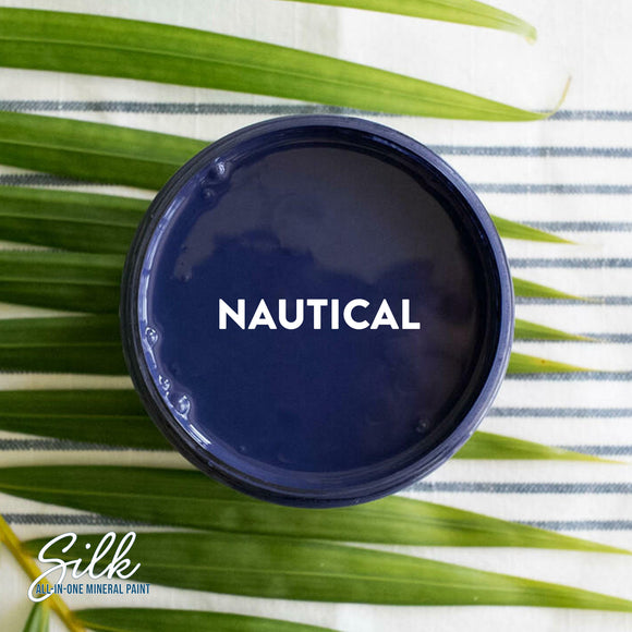 An arial view of an open container of Dixie Belle Paint Company's Nautical Silk All-In-One Mineral Paint is shown with white text reading Nautical.