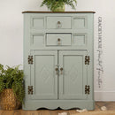 Vintage-style cabinet with decorative elements on a wooden floor, featuring the brand 'Gracie's House'.