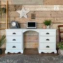 A vintage desk with 6 drawers features Dixie Belle's Oyster Silk All-In-One Mineral Paint.