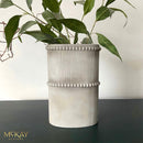 A cylindrical vase refurbished by McKay Designs features Dixie Belle's Oyster Silk All-In-One Mineral Paint.