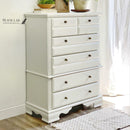 A 5-drawer chest dresser refurbished by Black Lab Furniture Revival features Dixie Belle's Oyster Silk All-In-One Mineral Paint.