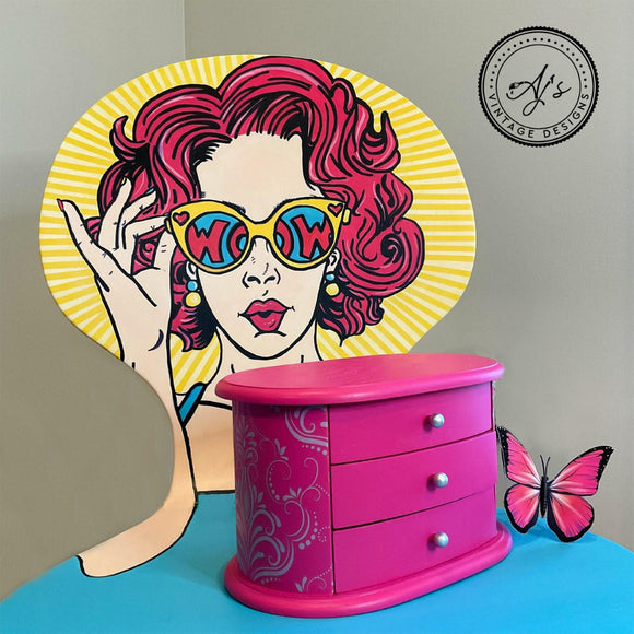 A small 3-drawer table-top jewelry box with a silver swirl stencil design on the sides features Dixie Belle's Prickly Pear Silk All-In-One Mineral Paint.