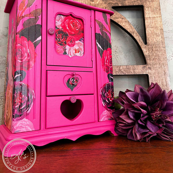 A vintage small table top jewelry armoire refurbished by AJ's Vintage Design has red flower rub-on transfers and features Dixie Belle's Prickly Pear Silk All-In-One Mineral Paint.