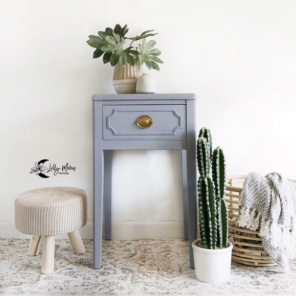 A vintage 1-drawer nightstand refurbished by Lilly Moon Vintage features Dixie Belle's Quiet Cove Silk All-In-One Mineral Paint.