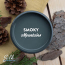 An arial view of an open container of Dixie Belle Paint Company's Smoky Mountains Silk All-In-One Mineral Paint is shown with white text reading Smoky Mountains.