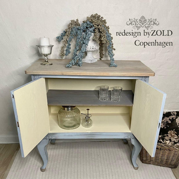 A vintage bar cabinet refurbished by Redesign by Zold Copenhagen features Dixie Belle's Sun Kissed Silk All-In-One Mineral Paint inside the cabinet.