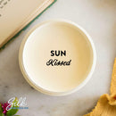 An arial view of an open container of Dixie Belle Paint Company's Sun Kissed Silk All-In-One Mineral Paint is shown with black text reading Sun Kissed.