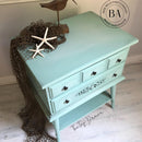 A vintage 2-drawer night stand refurbished by The Top Drawer features Dixie Belle's Tide Pool Silk All-In-One Mineral Paint.
