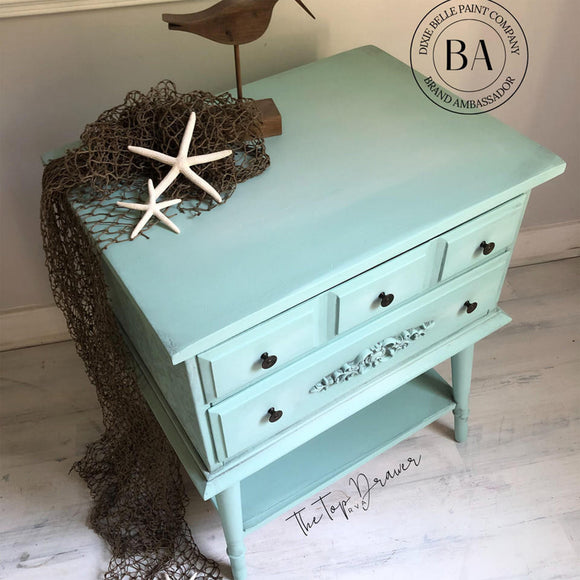 A vintage 2-drawer night stand refurbished by The Top Drawer features Dixie Belle's Tide Pool Silk All-In-One Mineral Paint.