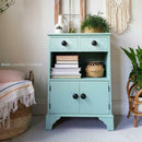 A small side table with 2 drawers, an open self, and cubby storage refurbished by Annie Loveday Furniture features Dixie Belle's Tide Pool Silk All-In-One Mineral Paint.