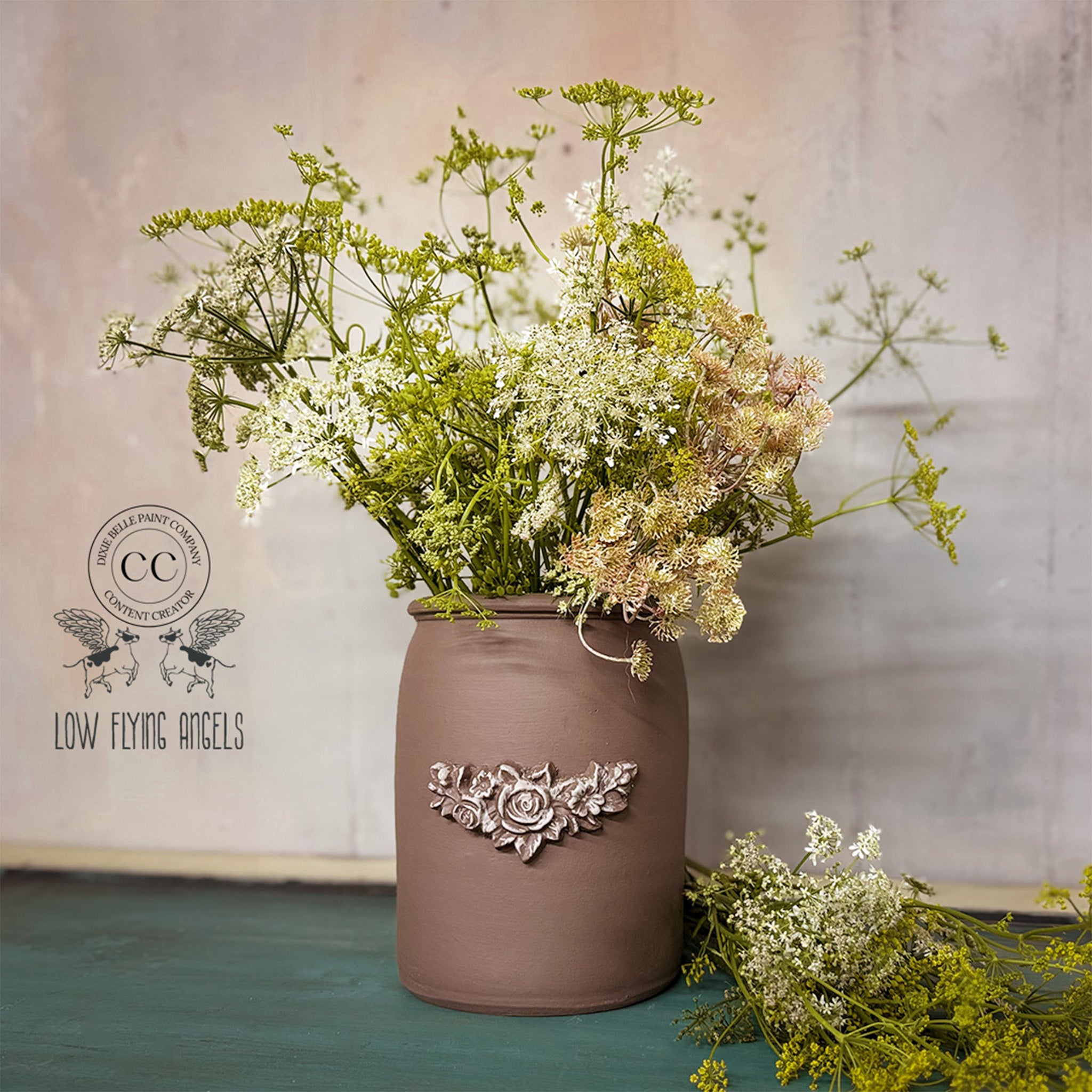 Decorative vase with floral arrangement on a textured surface