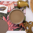 opened brown paint jar with floral and decorative elements