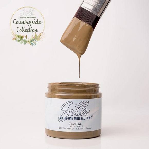 Jar of Silk All-in-One Mineral Paint with a brush dripping paint, labeled 'Countryside Collection'.