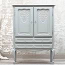 A small armoire features Dixie Belle's Wharf Silk All-In-One Mineral Paint.