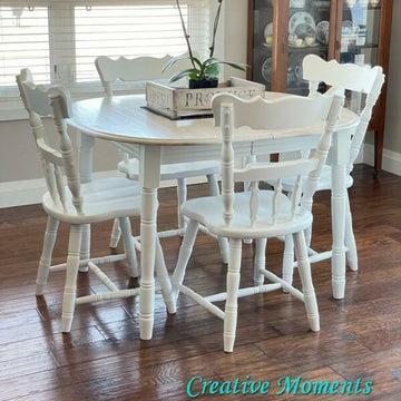 A wood dining table and 4 chairs refurbished by Creative Moments features Dixie Belle's Whitecap Silk All-In-One Mineral Paint.