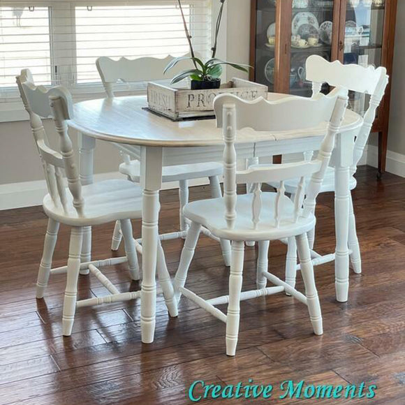 A wood dining table and 4 chairs refurbished by Creative Moments features Dixie Belle's Whitecap Silk All-In-One Mineral Paint.