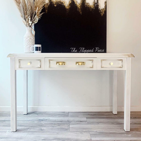 A console table with 3 small drawers refurbished by The Flipped Piece features Dixie Belle's Whitecap Silk All-In-One Mineral Paint.