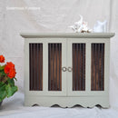 Light gray cabinet with wooden panels and decorative items on a white background