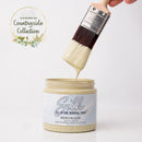 Silk All-in-One Mineral Paint being applied with a brush, featuring the Countryside Collection logo.