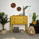 A vintage 2-drawer high leg dresser refurbished by Cherubs Chalks Interiors  features Dixie Belle's Yellowstone Silk All-In-One Mineral Paint.