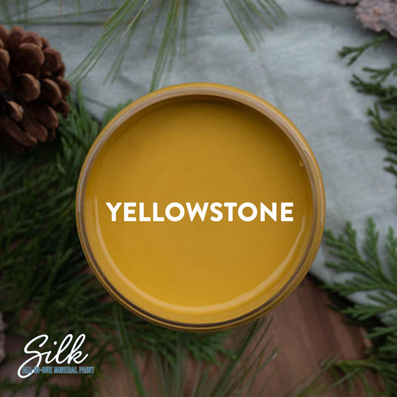 An arial view of an open container of Dixie Belle Paint Company's Yellowstone Silk All-In-One Mineral Paint is shown with white text reading Yellowstone.