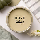 An arial view of an open container of Dixie Belle Paint Company's Olive Wood Chalk Mineral Paint is shown with black text reading Olive Wood.